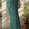 Close up of green polka dot dhoti style skirt with embroidered waist belt